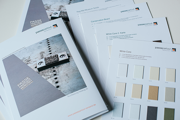 original_Color samples of passepartouts fanned out on a table
